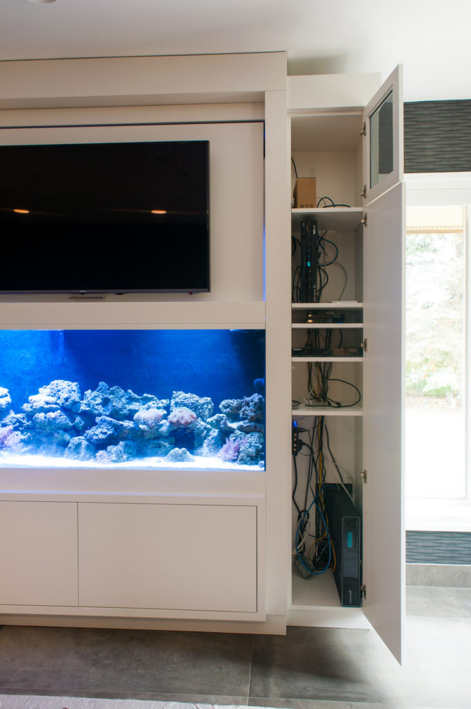 Built-in Saltwater fish tank cabinetry with flip up flat screen tv. 